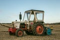 A vintage david brown white tractors with plough