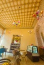 Vintage style cafeteria with decorated ceiling. Some multi-colored chandeliers adorn the ceiling. Royalty Free Stock Photo