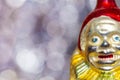 Vintage decorative christmas bauble in a shape of a crown jester against a colorful bokeh blury star background
