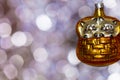 Vintage decorative christmas bauble in a shape of two kittens in a basket in golden color against a colorful bokeh background Royalty Free Stock Photo