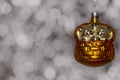 Vintage decorative christmas bauble in a shape of two kittens in a basket in golden color against a colorful bokeh background Royalty Free Stock Photo