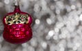 Vintage decorative christmas bauble in a shape of two kittens in a basket in pink color against a silver bokeh background