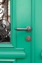 Vintage decorative handle and lock on green wooden door Royalty Free Stock Photo
