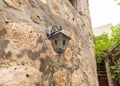 Vintage decorative metal lamp hanging on the wall in the famous artists village near Haifa in northern Israel