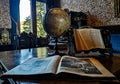 Vintage design interior of a cozy room with many books and old style world globe