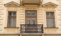 Vintage design windows with a balcony on the facade of the old