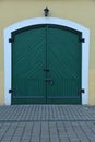 Old retro wooden green doors gates closed with metall padlock with hasp