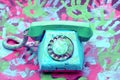A vintage dial phone from the 80s in abstract vivid colors.
