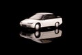 Vintage die-cast model car on the black reflective background Royalty Free Stock Photo