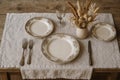 Vintage dining still life with elegant table setting and dried floral decor on rustic wooden table. concept of elegant dining Royalty Free Stock Photo