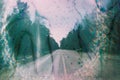 Vintage distressed photo of road through the forest.  Stains and scratches Royalty Free Stock Photo