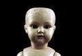 Vintage doll face isolated on black Royalty Free Stock Photo