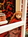 Vintage doll near the window Christmas decaration Royalty Free Stock Photo