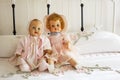 Vintage Dolls on Chanille Bedspread on Iron Bed Royalty Free Stock Photo