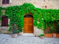 Vintage door in ancient building in Tuscany