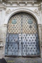 Vintage door of the Episcopal Palace in Cuenca with trim ornaments and forged metal details Royalty Free Stock Photo