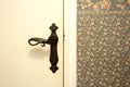 vintage door handle with colorful pattern wallpaper antique retro interior background texture