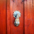 Vintage door knocker like hand on red Royalty Free Stock Photo