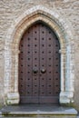 Vintage door on a old medieval stone building facade in old Tallinn, Estonia Royalty Free Stock Photo