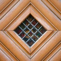 Vintage door spyhole with stained glass window and grid