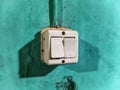 Vintage Double Light Switch on Teal Wall Texture Royalty Free Stock Photo