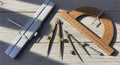 Vintage drafting tools arranged on rustic wooden surface in sunlight Royalty Free Stock Photo