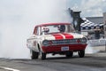 Vintage drag car making a smoke show on the track