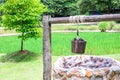Vintage draw well with wooden drive shaft bucket