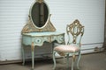 vintage dressing table with matching mirror and chair, ready for a princess or queen to get dressed