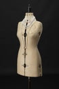 Vintage dressmakers dummy with pearl necklaces around its neck Royalty Free Stock Photo