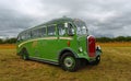 Vintage Duple bodied Dennis Lancet Coach parked isolated on grass.