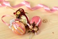 Vintage Easter decoration of three pink coloured Easter eggs decorated with shiny ribbons