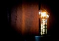 Vintage Edison light bulb illuminates on wood background. Royalty Free Stock Photo