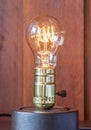 Vintage edison light bulb with wood background for hotel decorat Royalty Free Stock Photo