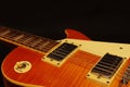 Vintage electric blues guitar closeup on black background. Shallow depth of field.