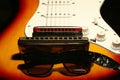 Vintage electric guitar, harmonica, sunglasses on black background Royalty Free Stock Photo