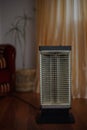 Vintage electric heater Ugolek in the room interior Royalty Free Stock Photo