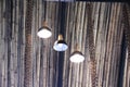 Vintage electric light lamps hang on ceiling bamboo roof interior inside on background Royalty Free Stock Photo