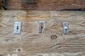 Vintage electrical switches haphazardly attached to a wood board