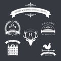 Vintage emblem with deer, kyes, weather vane, bed and old building for your hotel and hostel logo. Royalty Free Stock Photo