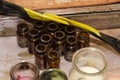 Ancient empty small bottles of dark glass stand on a table covered with dust Royalty Free Stock Photo