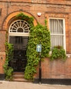 Vintage entrance with large arched doorway surrounded by Ivy
