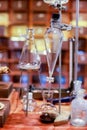 Vintage equipment of chemical laboratory on wooden table.