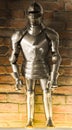 A vintage european full body armor suit against the brick wall background