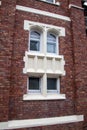 Vintage European red brick building texture with a beautiful white window and trim Royalty Free Stock Photo