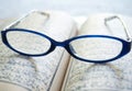 Vintage eyeglasses on old blur Arabic book (Ramadan season)