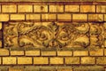 Vintage facade decoration made of concrete molding on rustic brick wall