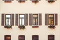 Vintage facade of typical european building. Retro window with flowers. Window box flower arrangement Royalty Free Stock Photo