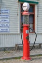 Vintage factory made petrol pump in front of Jarnhandel hus Ironmongers store in Skansen at sunny autumn day. Stockholm, Sweden