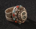 Vintage, fancy ring with precious, colorful stone isolated on a black background